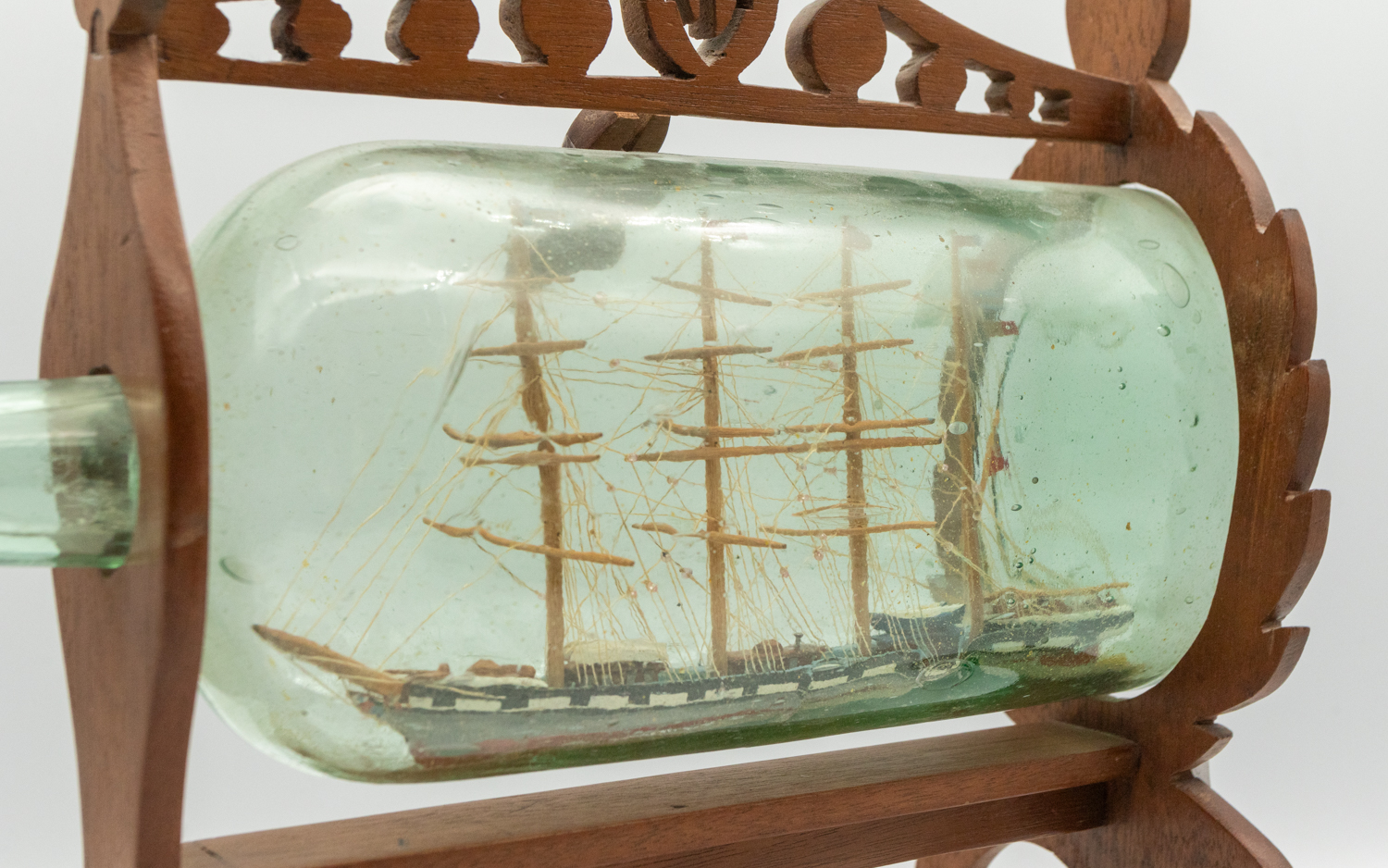 Two 19th century wooden models of Ship's in glass bottles; one encased in a light wooden frame of - Image 2 of 4