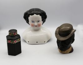 A 20th century black ground tea cannister of hexagonal shape, detachable cover with floral design,