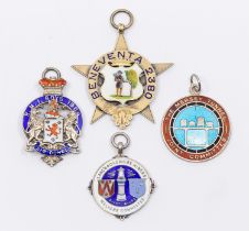 A collection of fob medals to include: a Victorian silver gilt star shaped fob medal, central shield