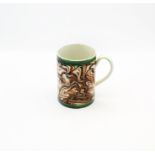 A creamware  cylindrical mug, brown, ochre and black marbled decoration with green ribbed bands to