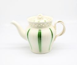 A Leeds creamware engine turned teapot and cover, with a pierced gallery collar and a twisted