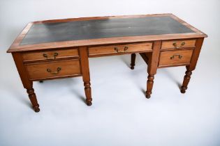 A mid-20th century five drawer desk, on turned legs, with leather insert, 185 x 75 x 75cm