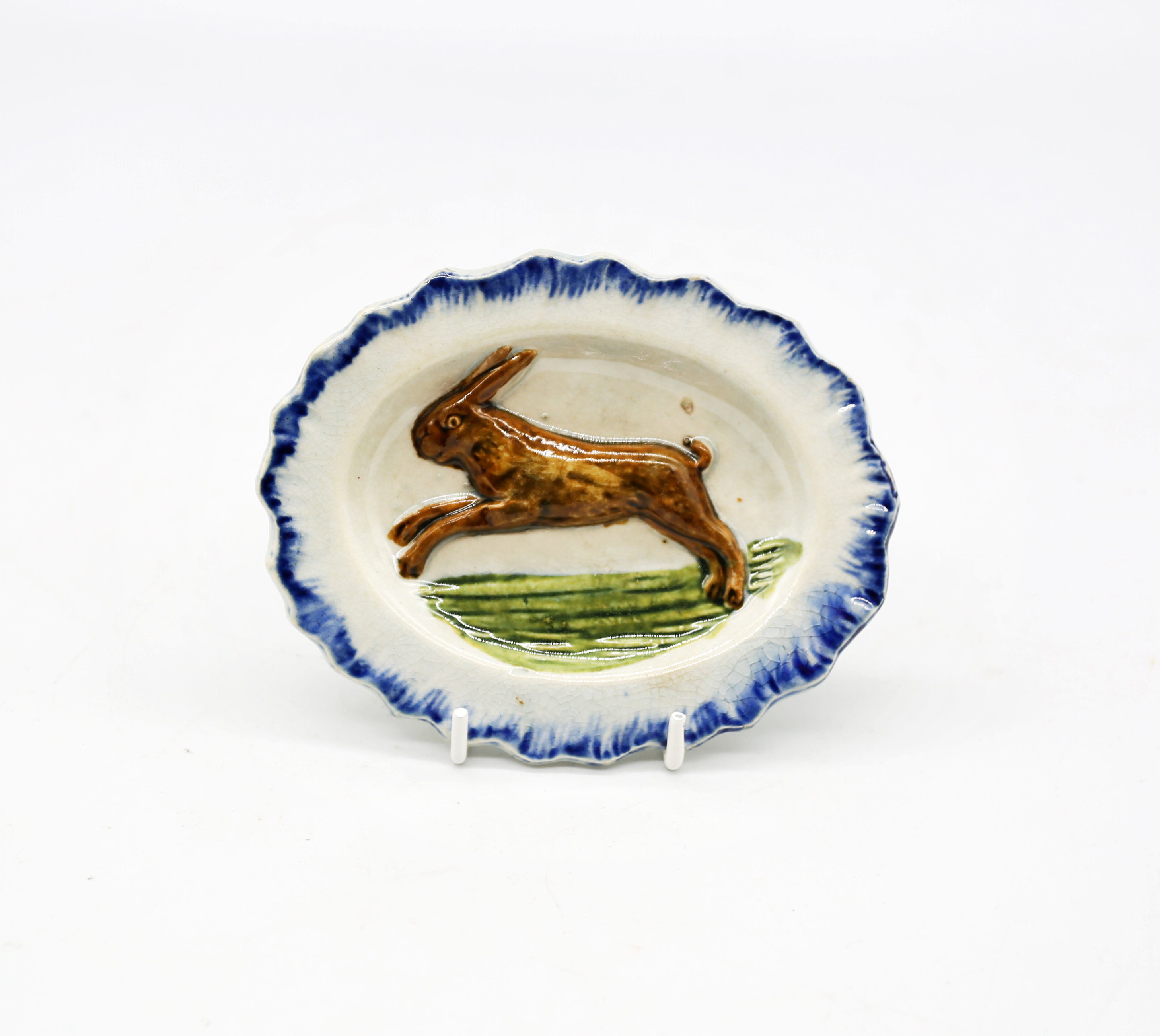 A pearlware ‘Toy’ oval platter with a rabbit moulded in the centre with a blue feather moulded