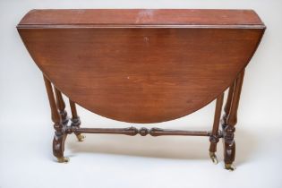 A gateleg occasional table in mahogany, on casters