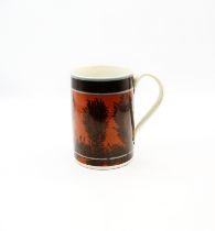 A creamware Mocha mug, dark terracotta ground with black feathered trees and a black and three