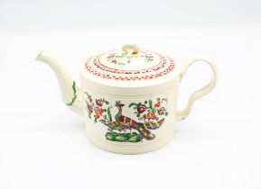 A Leeds creamware cylindrical teapot and cover, painted in bright enamels with exotic birds on rocky