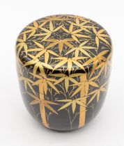 A 20th century Japanese black and gold lacquered tea cannister and cover, decorated with bamboo in