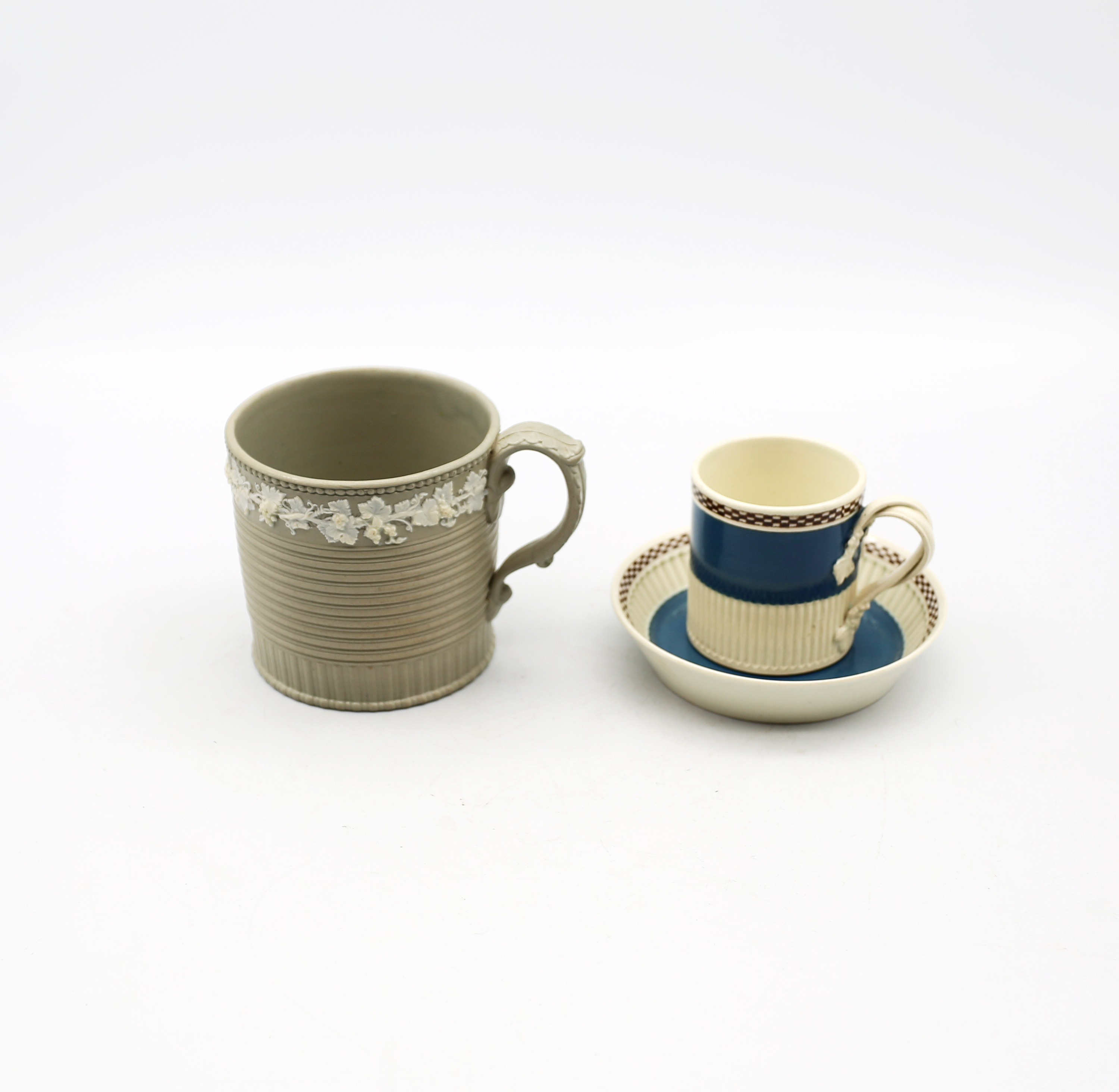 A Drabware sprigged mug, grey ground with grape and vine sprigging, along with a Mocha ware coffee