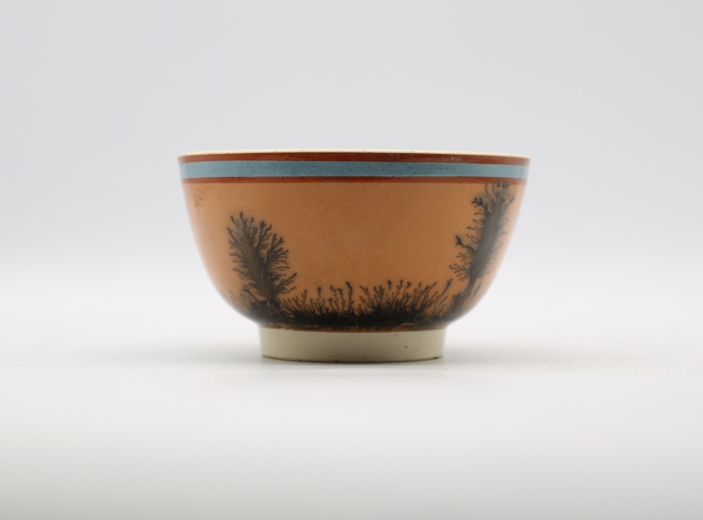 A small creamware Mocha bowl, orange ground, with black trees and a blue band.  Circa 1800-1820. - Image 3 of 5