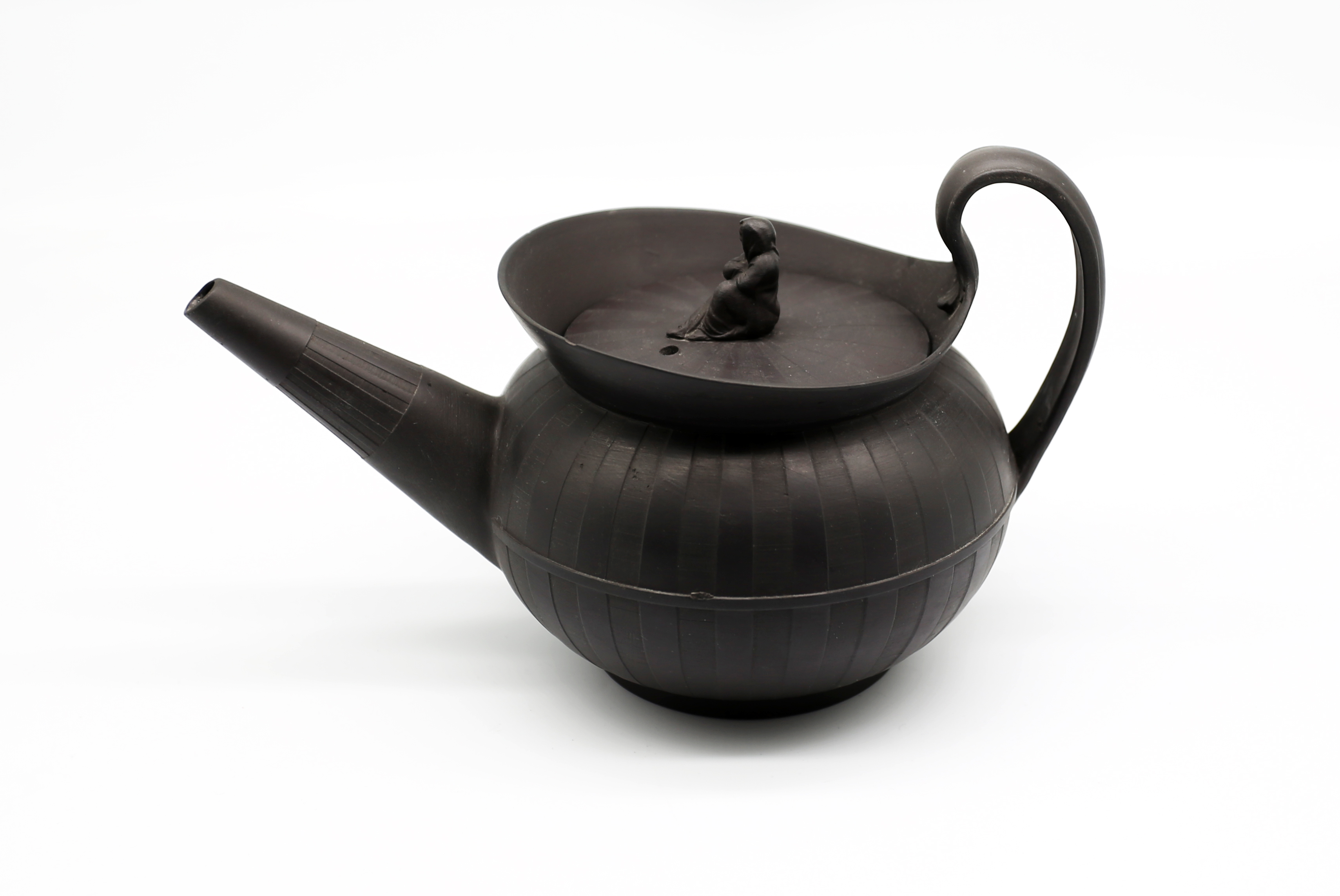 A Wedgwood black basalt teapot and cover with a flared lip.  The cover has a widow finial.