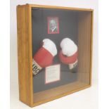 Boxing: A framed and glazed pair of signed Henry Cooper boxing gloves, signed by Cooper to both