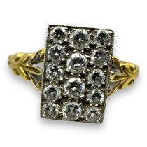 An 18ct gold diamond panel ring. Featuring a rectangular panel pave set with 14 round brilliant