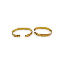 A pair of Trinidadian Indian torque bangle in precious yellow metal. Tests as as 10ct gold. Gross