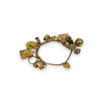 A 9ct gold charm bracelet with 15 charms to include a full sovereign, a photograph album charm, a