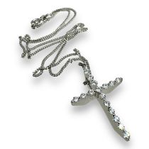 A diamond set cross with a 9ct gold curb chain. The cross is in precious white metal, stamped K18