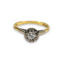 An 18ct gold illusion set diamond solitaire ring. Featuring a round brilliant cut estimated 0.20