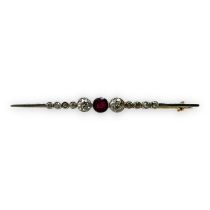 A fine Edwardian ruby and diamond bar brooch. Featuring a central millgrain set 5mm diameter round