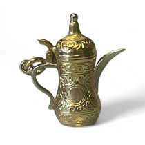 A "750" stamped coffee pot charm. Tests as 18ct gold. Gross weight approximately 5.74 grams.