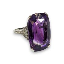 An Art Deco style amethyst and diamond cocktail ring. The amethyst measures approximately 23.5mm