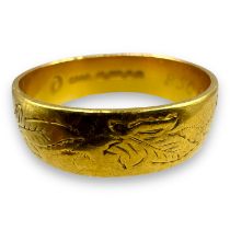 A 22ct gold engraved band ring, engraved with alight vine leaf pattern.  Size P. Approximate