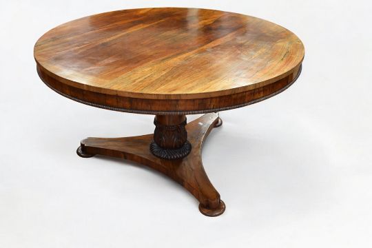 An early Victorian round top mahogany breakfast table with tilt top ornate supports on three splayed - Image 1 of 3