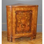 A 19th Century Dutch floral and figural marquetry floor standing corner cupboard, the panel door