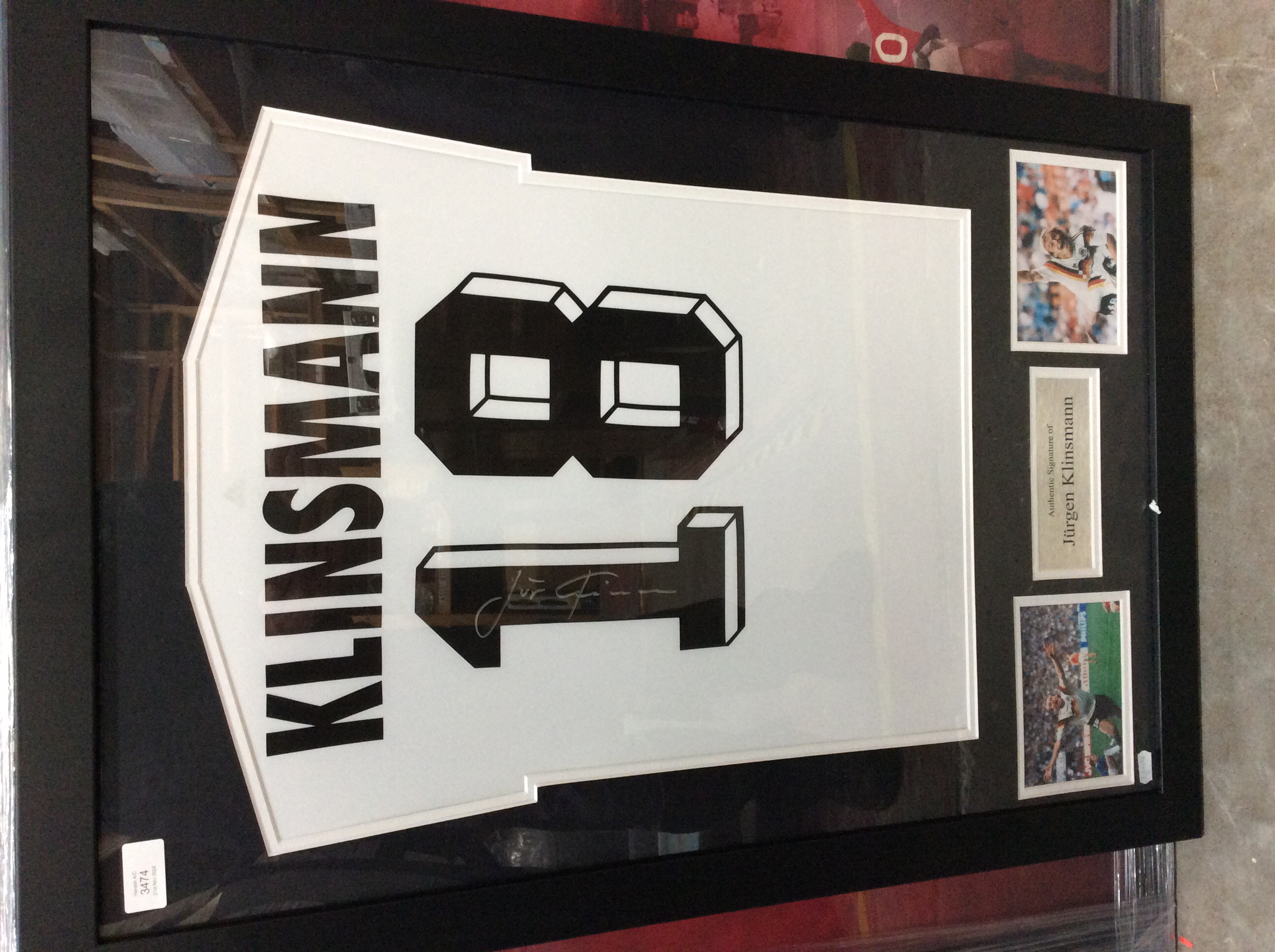 A signed and framed white Germany football shirt signed by Jurgen Klinsmann, complete with two