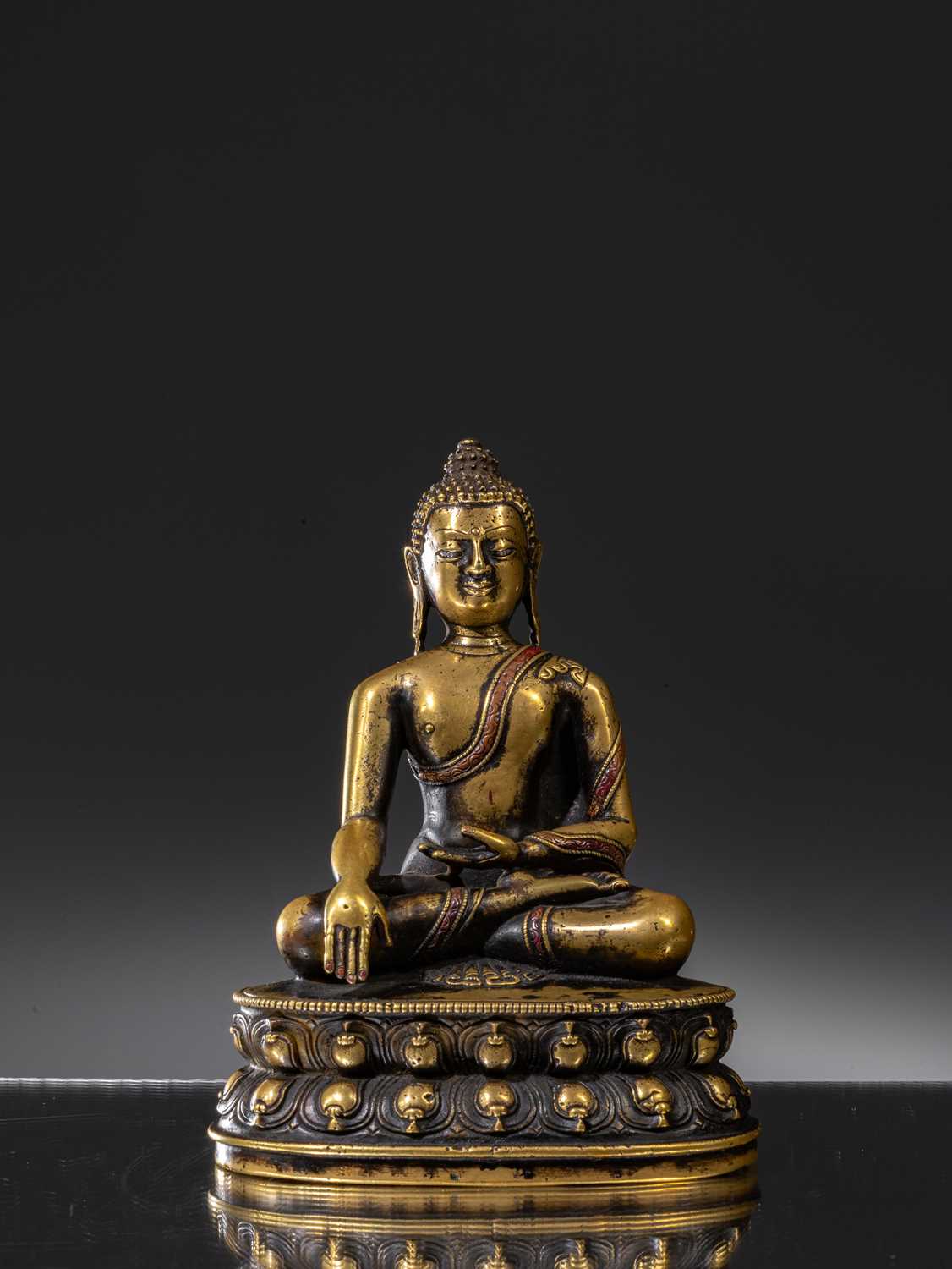 A LARGE SILVER AND COPPER INLAID BRONZE FIGURE OF SHAKYAMUNI BUDDHA, TIBET, 15TH CENTURY