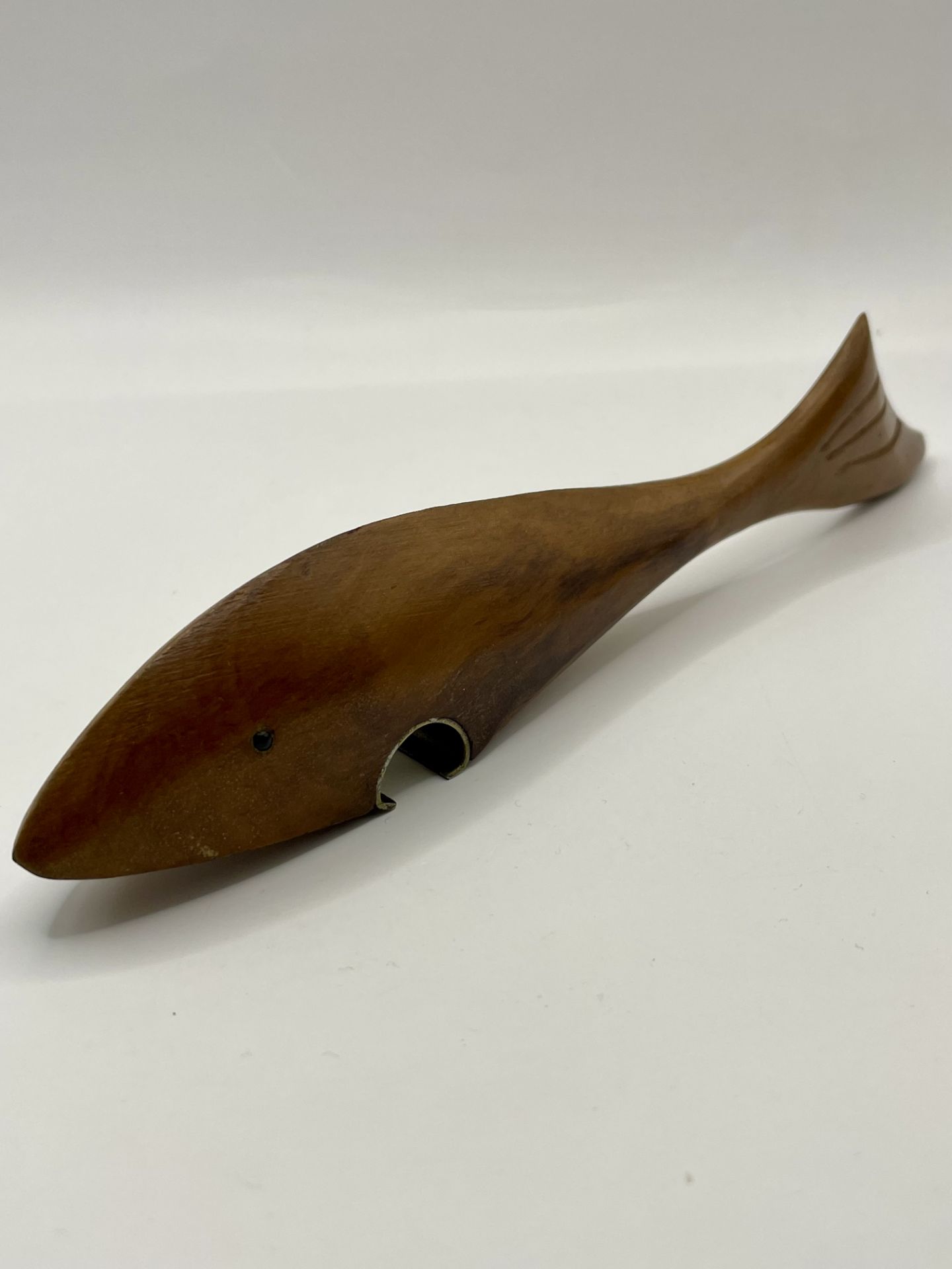 A Retro 1950-70s Swedish Fish Bottle opener made from teak wood.