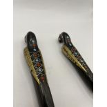 Spoon and Fork with detailed birds as handles and inlaid silver and other metals for detail.