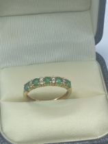 EMERALD AND DIAMOND HALF ETERNITY RING SET IN YELLOW METAL TESTED AS AT LEAST 9ct SIZE K 1/2