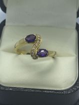 AMETHYST AND DIAMOND RING SET IN YELLOW METAL TESTED AS AT LEAST 15ct GOLD WEIGHT 4.86g SIZE S 1/2