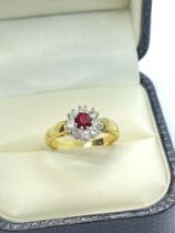 RED AND WHITE STONE SET FLOWER RING IN YELLOW METAL TESTED AT LEAST 9ct 1.98g WEIGHT SIZE J