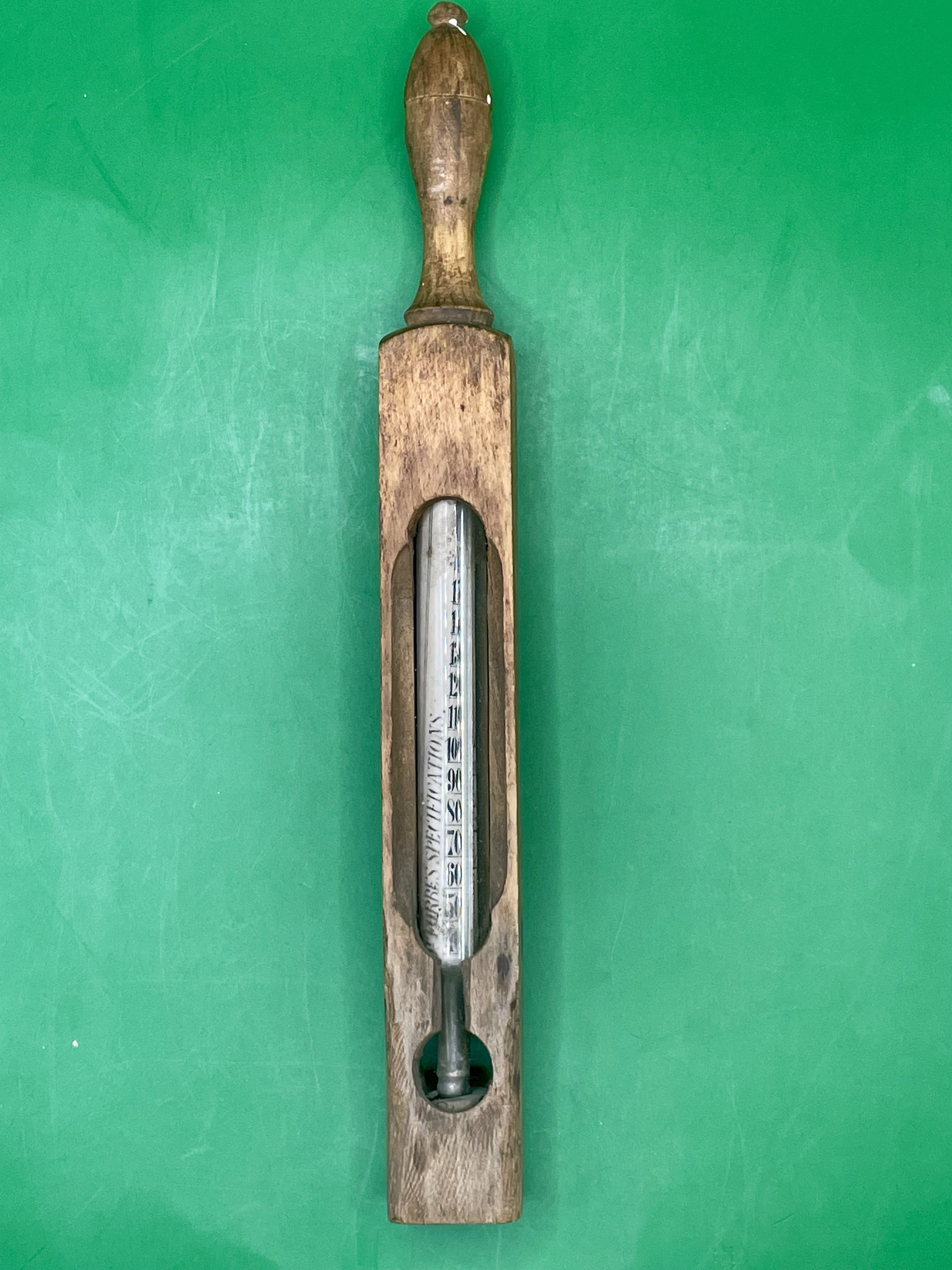 An antique bath wood and glass water thermometer.  Great condition. 