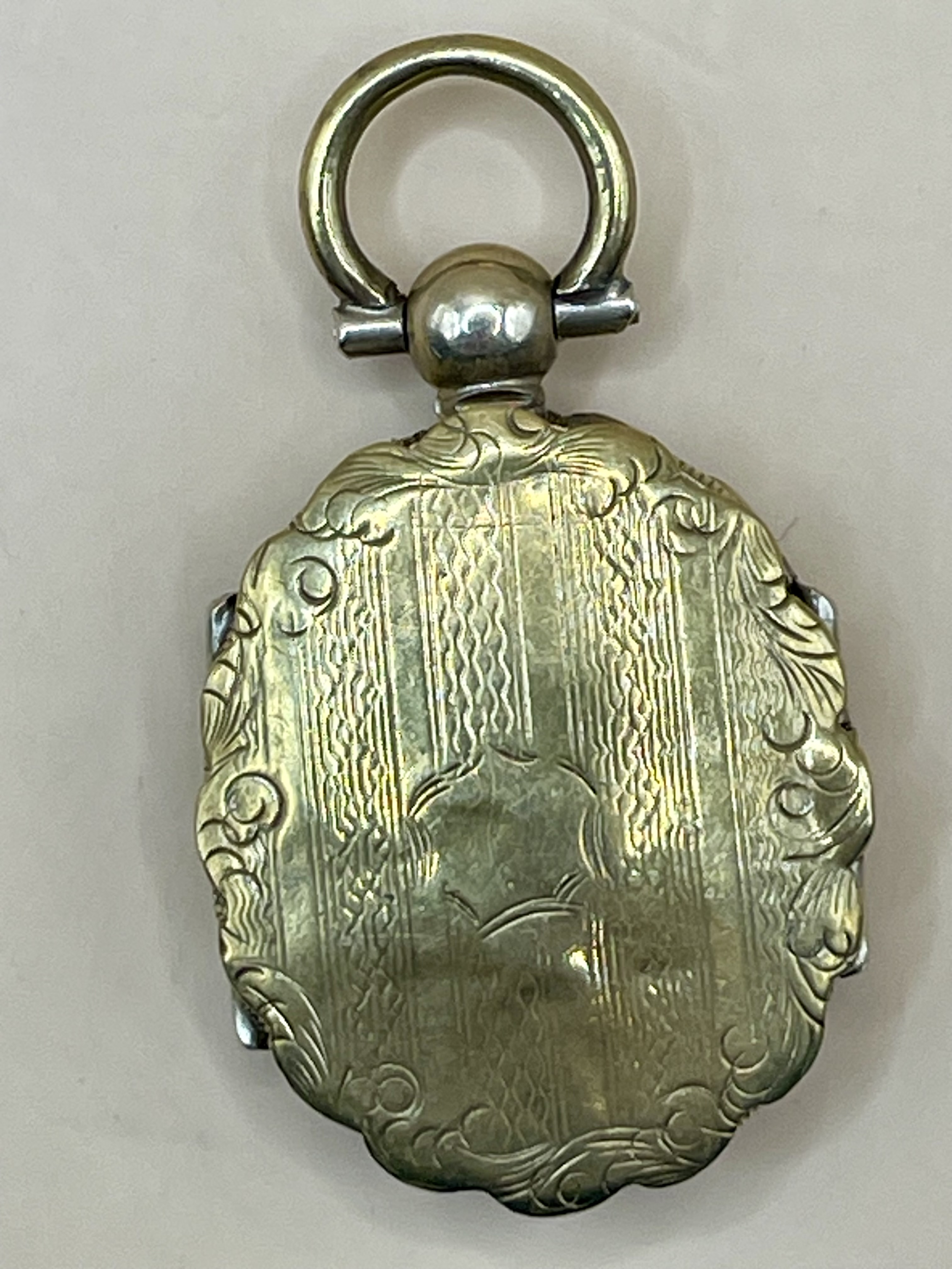 A Victorian gold coloured locket which opens on both sides very well made please see photos for bett