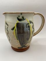 Lovely studio pottery jug with great art on side.