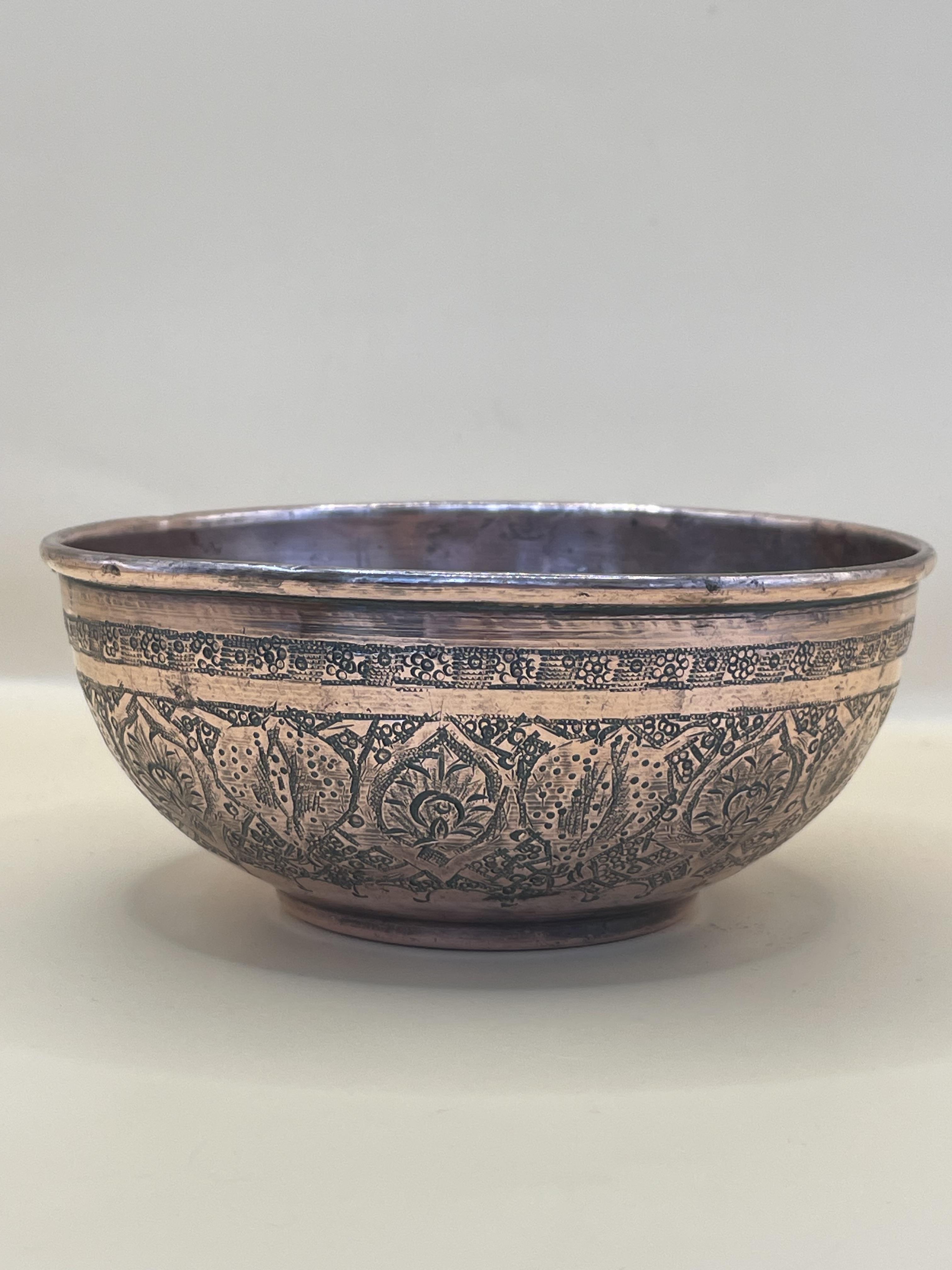  Century Indian Copper Bowl, having embossed decoration all over and standing on a shallow foot base