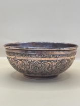 Century Indian Copper Bowl, having embossed decoration all over and standing on a shallow foot base