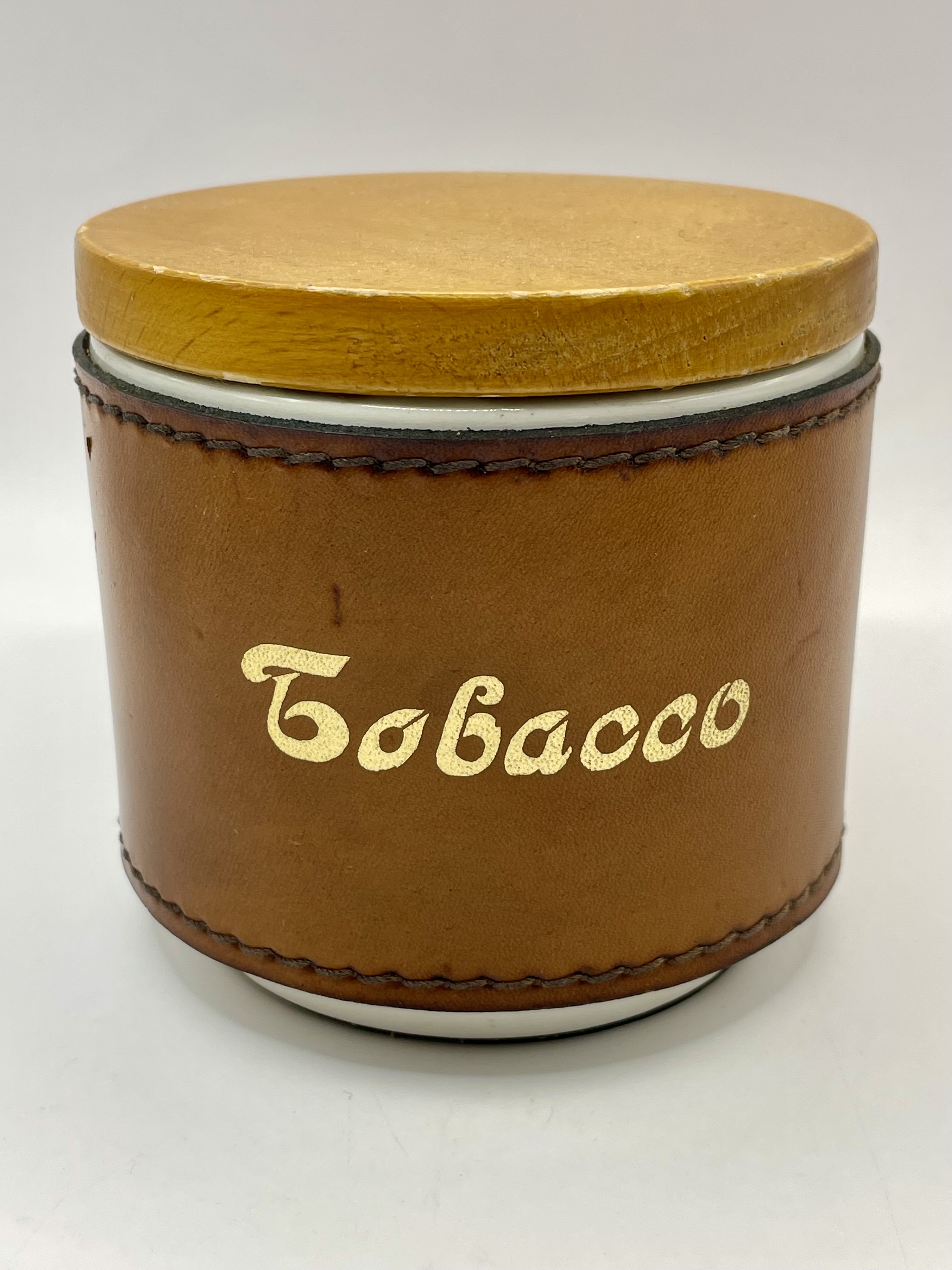 A 1950s mid century tobacco ceramic jar with leather surround lovely condition. Please see photos.