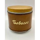 A 1950s mid century tobacco ceramic jar with leather surround lovely condition. Please see photos.