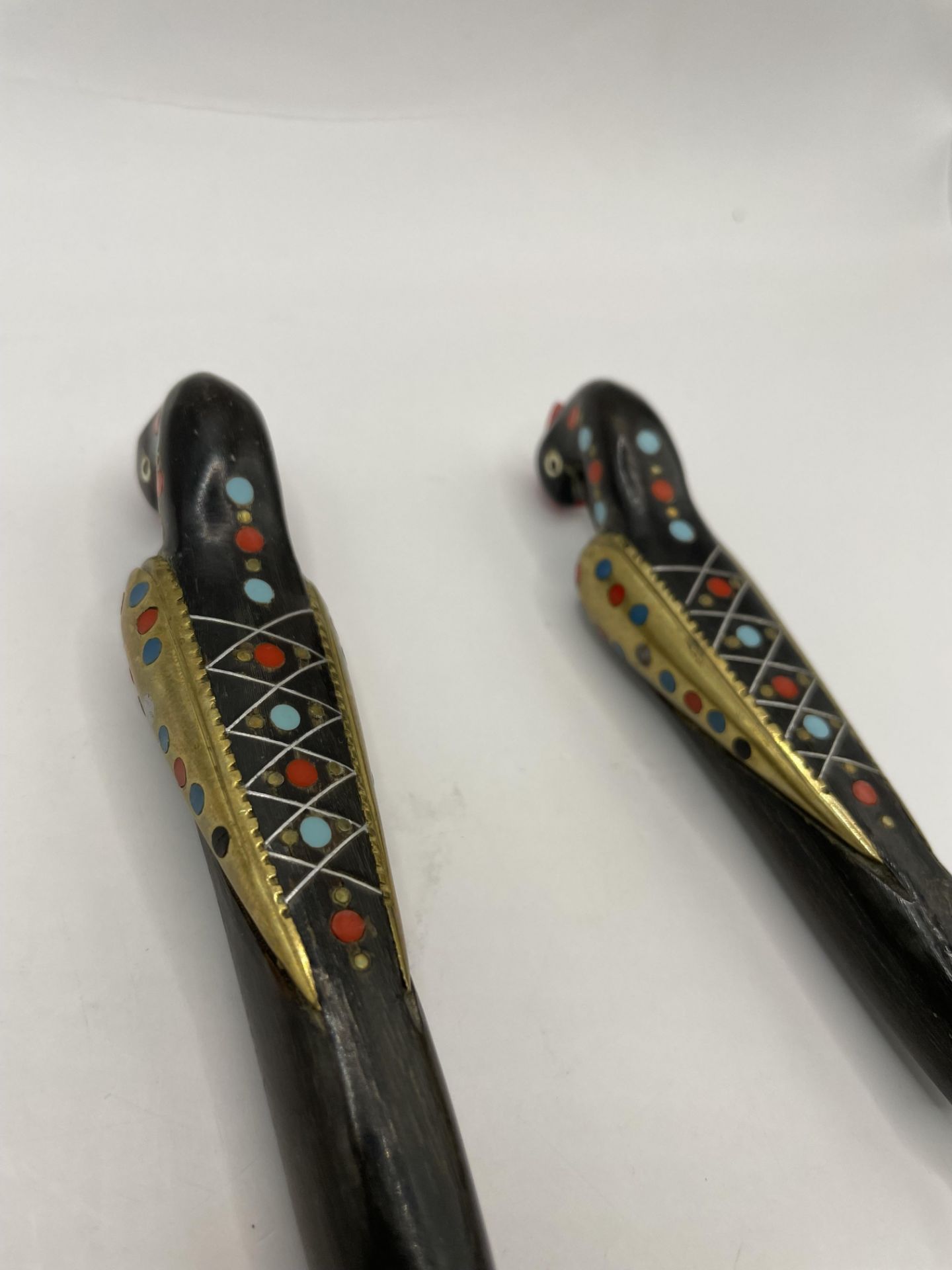 Spoon and Fork with detailed birds as handles and inlaid silver and other metals for detail.