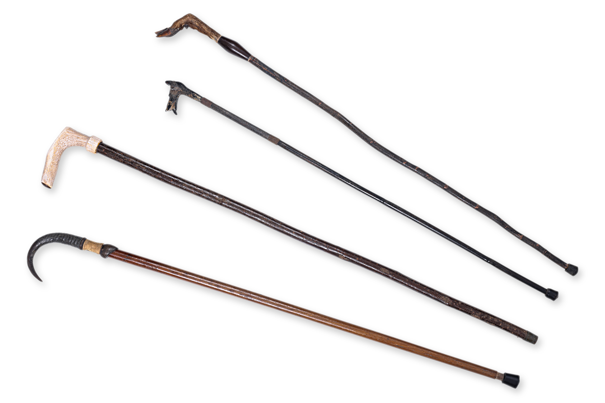A GROUP OF FOUR WALKING STICKS