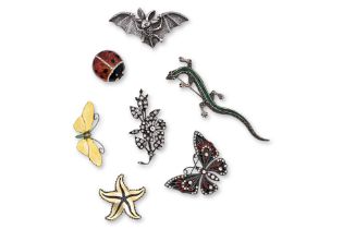 A GROUP OF SEVEN SILVER AND ENAMEL BROOCHES