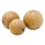 A GROUP OF THREE LARGE DECORATIVE WOODEN BALLS