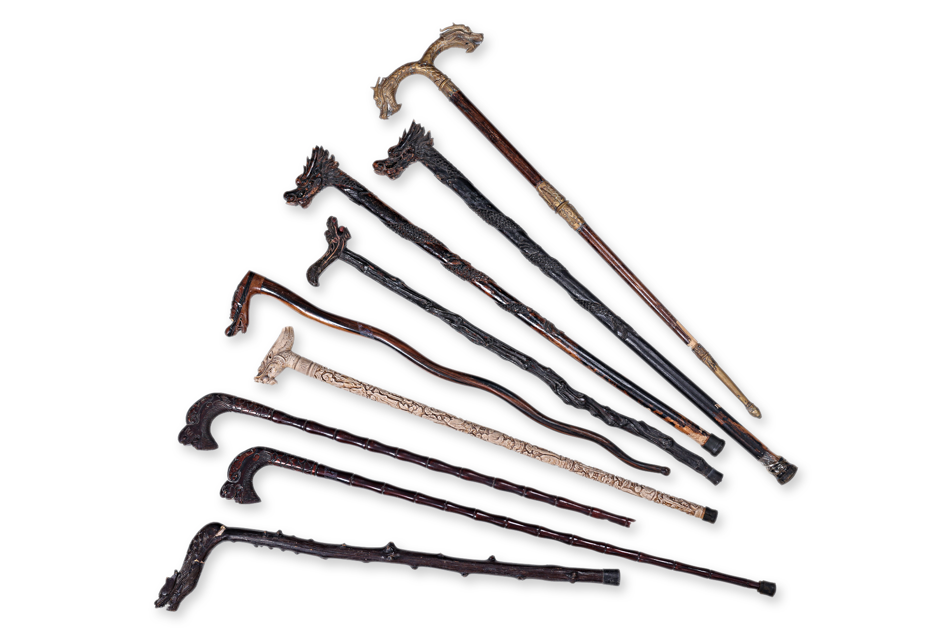 A GROUP OF NINE DRAGON HANDLED WALKING STICKS