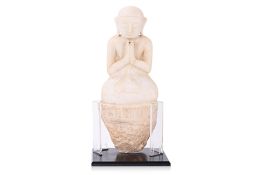 A BURMESE ALABASTER KNEELING MONK STATUE