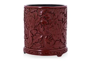 A CARVED CINNABAR LACQUER BRUSH POT