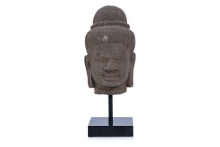 A CAMBODIAN KHMER CARVED STONE HEAD OF A DEITY
