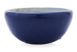 A BLUE MONOCHROME GLAZED PORCELAIN ALMS BOWL