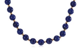 A LAPIS LAZULI BEAD NECKLACE WITH GOLD SPACINGS